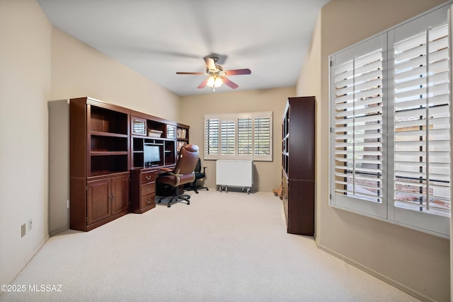 carpeted office featuring ceiling fan