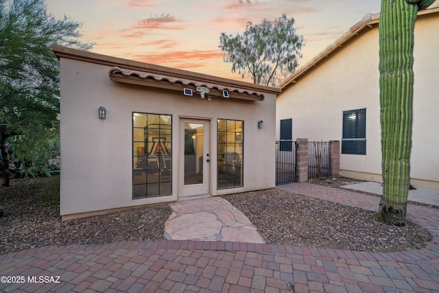 view of exterior entry at dusk