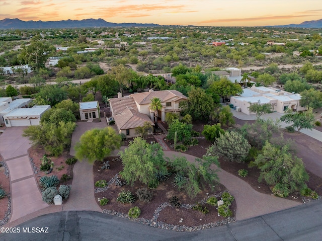 aerial view at dusk featuring a mountain view