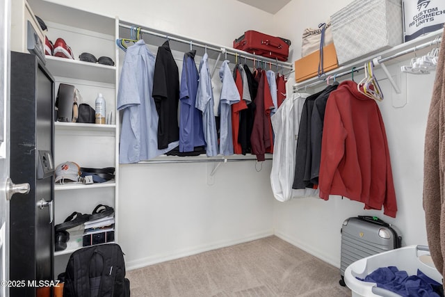 walk in closet featuring light colored carpet