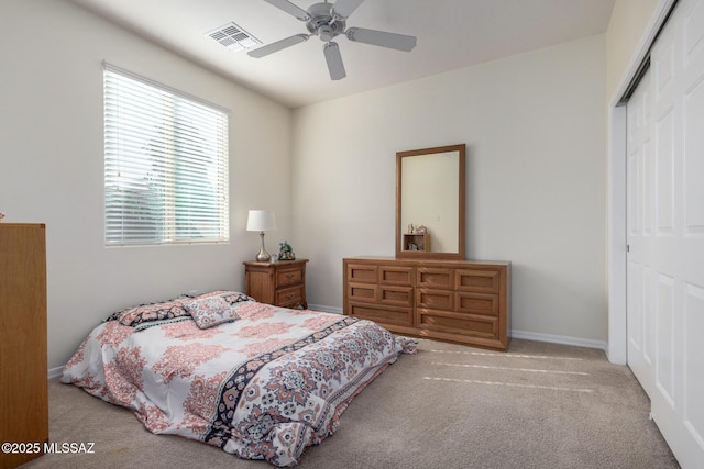 bedroom featuring a closet, light carpet, and ceiling fan