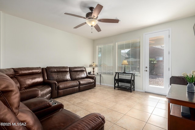 living room with ceiling fan and light tile patterned flooring