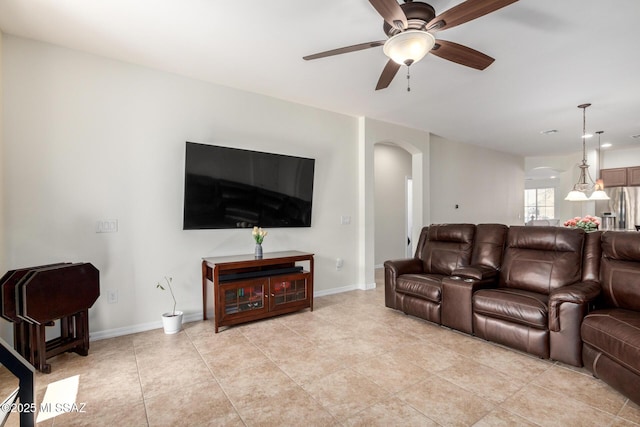 tiled living room with ceiling fan