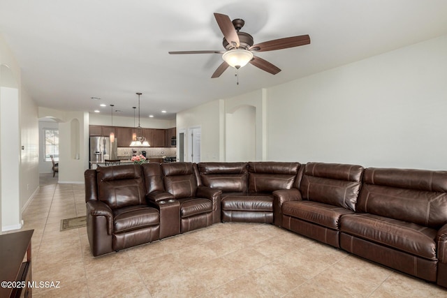 tiled living room with ceiling fan