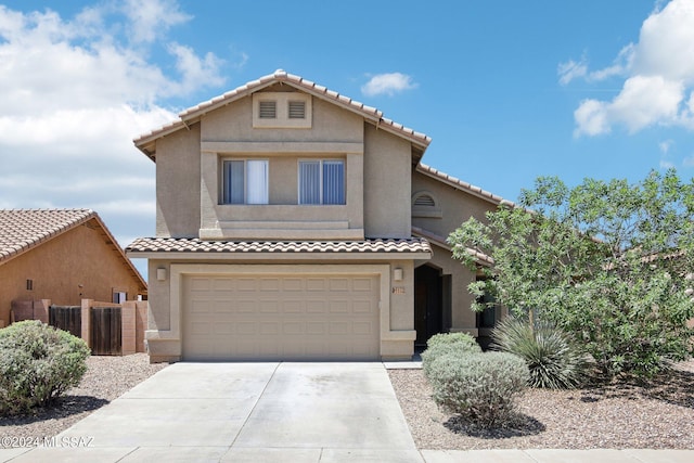 view of front of home with a garage, fence, driveway, a tiled roof, and stucco siding