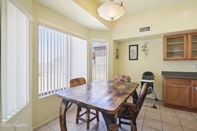 dining space featuring visible vents, baseboards, and light tile patterned floors