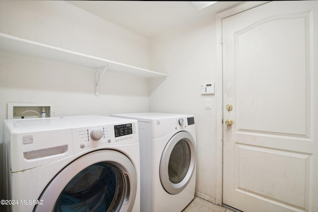 washroom featuring laundry area and washing machine and clothes dryer