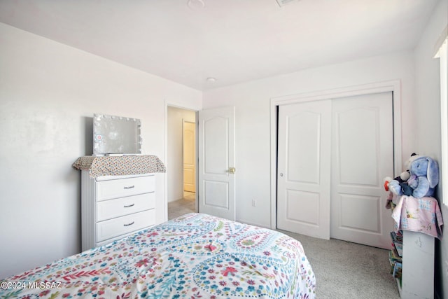 bedroom with light carpet and a closet