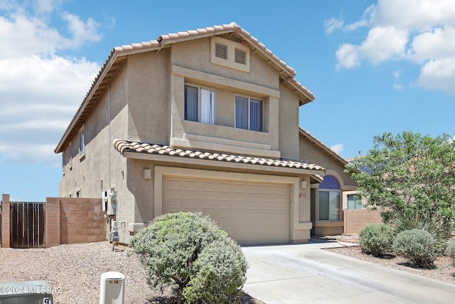 view of front of house featuring an attached garage, fence, concrete driveway, and stucco siding