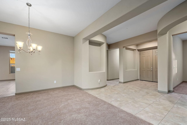 empty room featuring visible vents, baseboards, light carpet, light tile patterned floors, and a notable chandelier