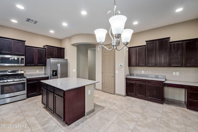 kitchen with dark brown cabinets, pendant lighting, recessed lighting, arched walkways, and stainless steel appliances