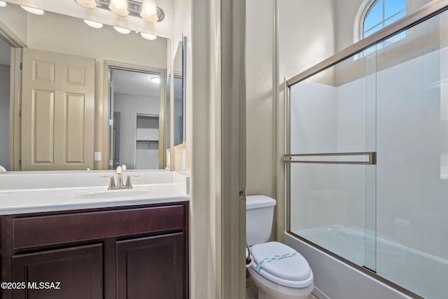 full bath featuring vanity, toilet, and enclosed tub / shower combo