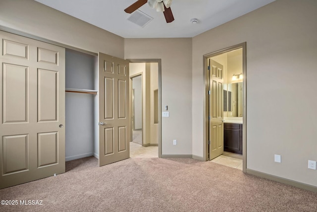 unfurnished bedroom featuring light carpet, visible vents, baseboards, and a closet