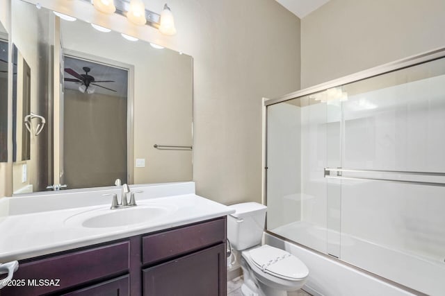 full bathroom with vanity, enclosed tub / shower combo, toilet, and ceiling fan