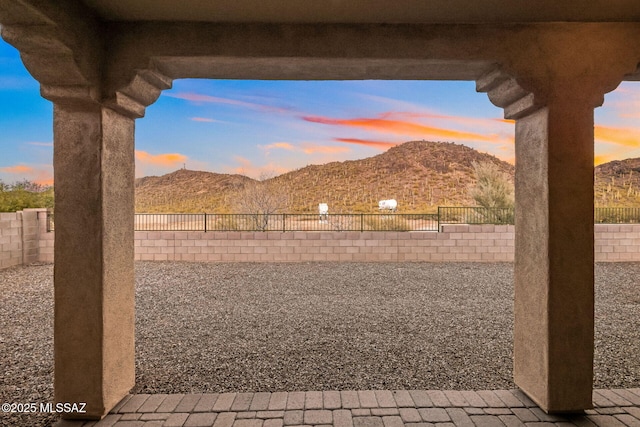 view of yard with a mountain view, a fenced backyard, and a patio area