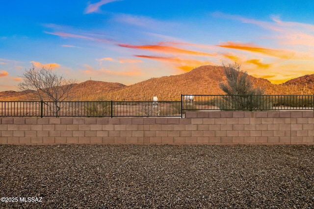 view of yard with fence and a mountain view