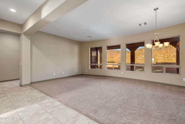 empty room with visible vents, baseboards, light colored carpet, and an inviting chandelier