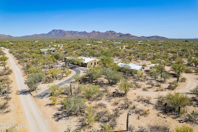 birds eye view of property with view of desert and a mountain view