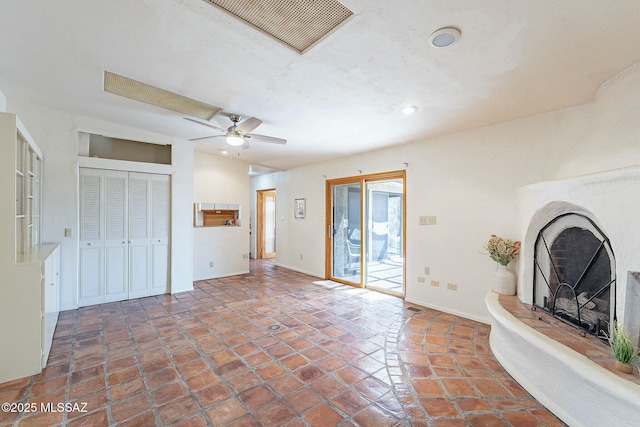 unfurnished living room featuring a ceiling fan, visible vents, baseboards, recessed lighting, and a fireplace with raised hearth