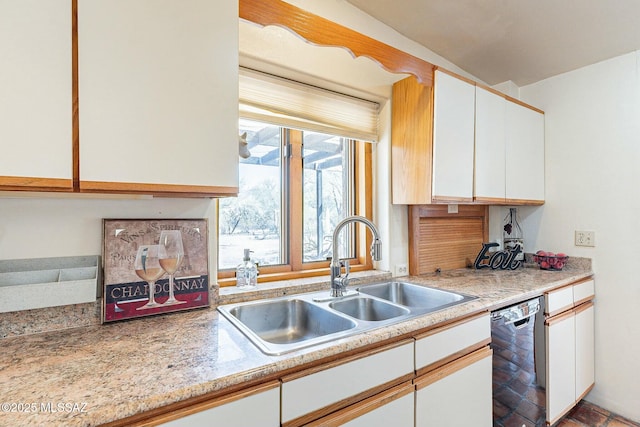 kitchen featuring a sink, dishwasher, light countertops, and white cabinetry