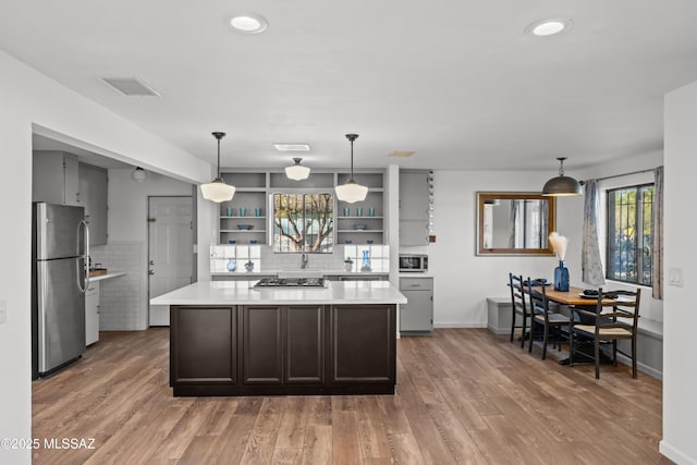 235 N Tucson Blvd, Tucson, AZ 85716 - kitchen with light wood finished floors, light countertops, open shelves, and appliances with stainless steel finishes