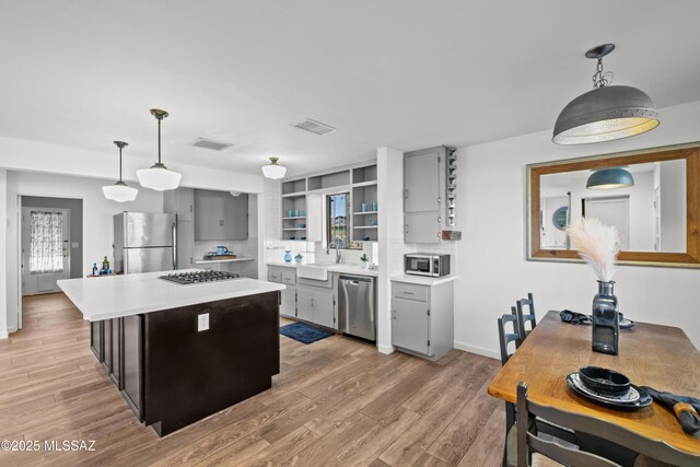 235 N Tucson Blvd, Tucson, AZ 85716 - kitchen featuring stainless steel appliances, light wood-style floors, light countertops, and open shelves