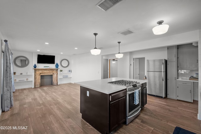 235 N Tucson Blvd, Tucson, AZ 85716 - kitchen with visible vents, light countertops, wood finished floors, stainless steel appliances, and pendant lighting