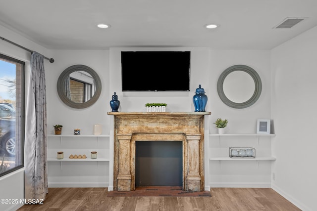 235 N Tucson Blvd, Tucson, AZ 85716 - unfurnished living room with visible vents, baseboards, recessed lighting, and wood finished floors