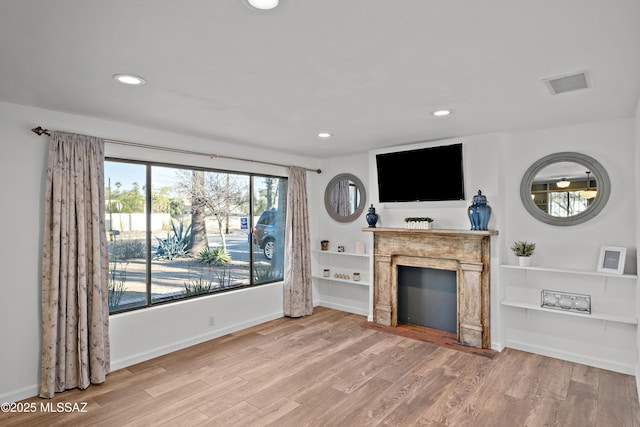 235 N Tucson Blvd, Tucson, AZ 85716 - living area featuring a fireplace with flush hearth, wood finished floors, visible vents, and recessed lighting