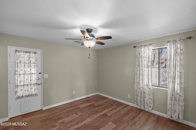 235 N Tucson Blvd, Tucson, AZ 85716 - spare room with baseboards, a ceiling fan, wood finished floors, and a healthy amount of sunlight