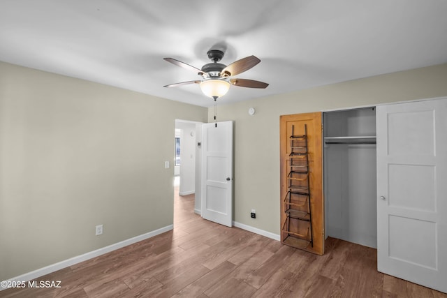 235 N Tucson Blvd, Tucson, AZ 85716 - unfurnished bedroom with a closet, baseboards, ceiling fan, and wood finished floors
