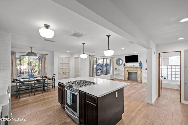 235 N Tucson Blvd, Tucson, AZ 85716 - kitchen featuring visible vents, stainless steel gas range, and light wood finished floors