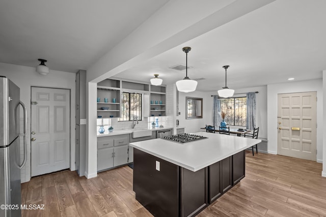 235 N Tucson Blvd, Tucson, AZ 85716 - kitchen with visible vents, open shelves, light countertops, appliances with stainless steel finishes, and wood finished floors