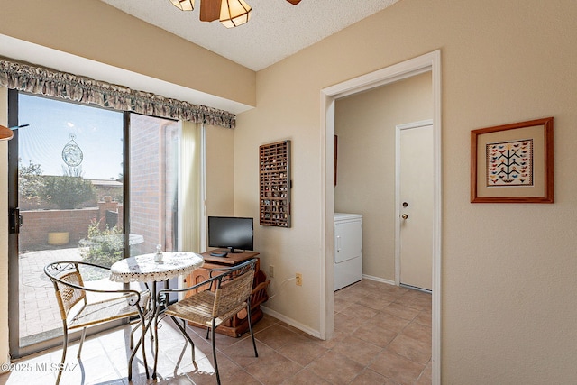 dining room featuring baseboards, ceiling fan, washer / clothes dryer, a textured ceiling, and light tile patterned flooring