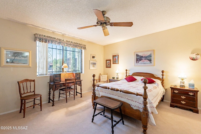 carpeted bedroom featuring ceiling fan, baseboards, and a textured ceiling