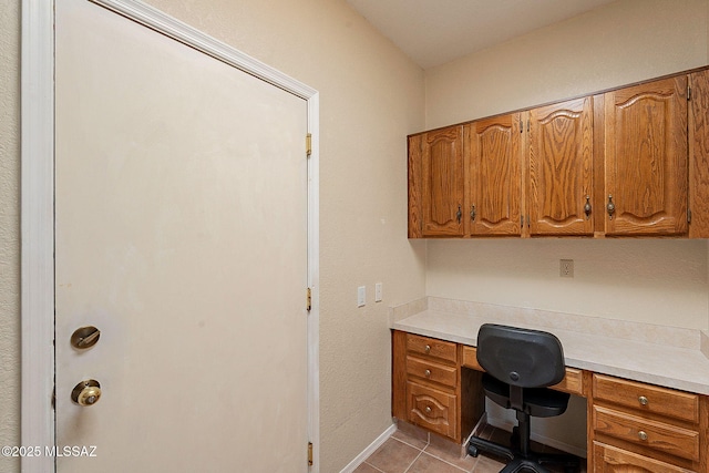 home office featuring baseboards and light tile patterned flooring