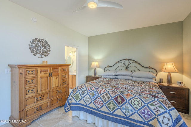 bedroom with light tile patterned floors, a ceiling fan, and connected bathroom