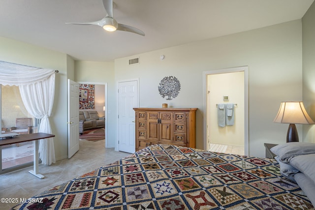 bedroom featuring light tile patterned floors, ensuite bath, visible vents, and a ceiling fan