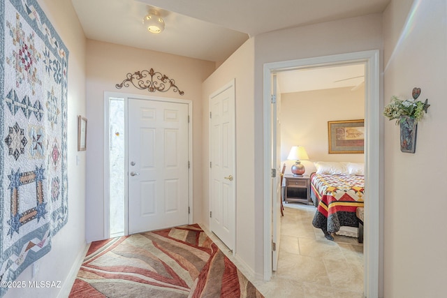 foyer entrance featuring baseboards