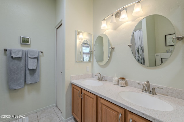 bathroom with double vanity, a sink, and tile patterned floors