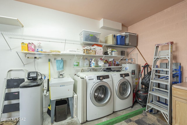 washroom with washing machine and dryer, laundry area, and electric water heater