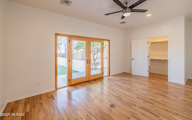 interior space featuring french doors, light wood finished floors, visible vents, and baseboards