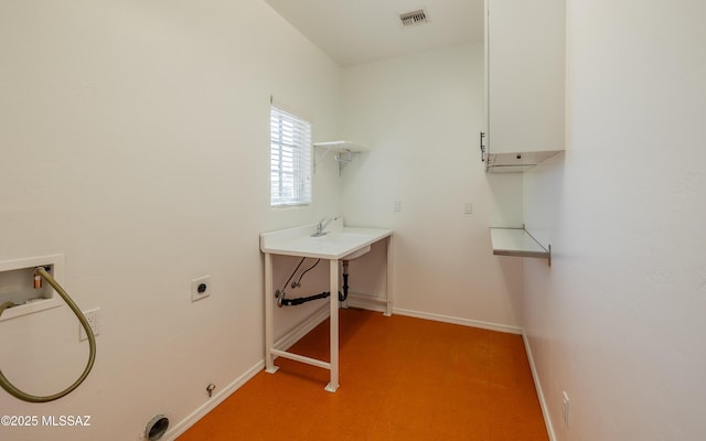 washroom featuring cabinet space, baseboards, visible vents, and electric dryer hookup