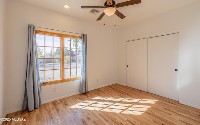 unfurnished bedroom featuring light wood finished floors, visible vents, a closet, and recessed lighting