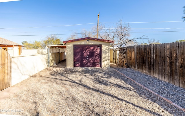 view of shed featuring gravel driveway and a fenced backyard