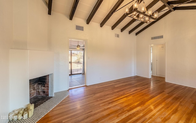 unfurnished living room with a fireplace with flush hearth, visible vents, and wood finished floors