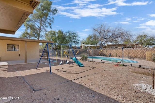 view of play area featuring fence and a fenced in pool