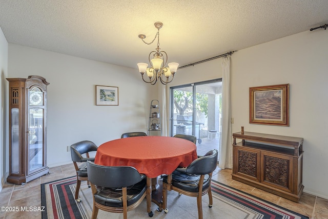 dining room with a textured ceiling and a notable chandelier