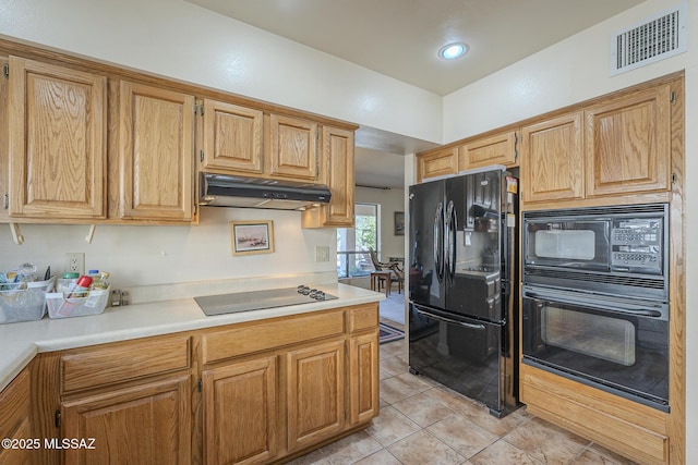 kitchen with black appliances, under cabinet range hood, visible vents, and light countertops