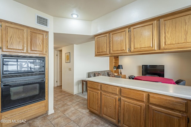 kitchen with light countertops, visible vents, black appliances, and light tile patterned floors